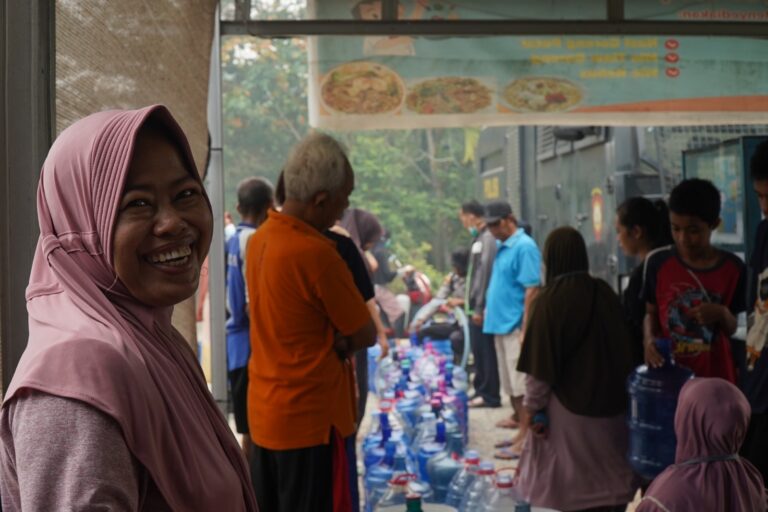 "Ratusan warga Desa Arang Limbung Kubu Raya padati armada water cannon polisi demi pasokan 6.000 liter air bersih, petugas turut bagikan masker cegah asap karhutla."